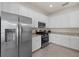 Well-appointed kitchen features white cabinets, stainless steel appliances, and granite countertops at 17610 Polo Trl, Bradenton, FL 34211