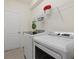 Bright laundry room featuring new, modern washer and dryer and wire rack at 17610 Polo Trl, Bradenton, FL 34211