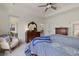 Spacious main bedroom with tray ceilings, balcony access, dresser, and a sitting area at 17610 Polo Trl, Bradenton, FL 34211