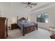 Comfortable main bedroom with ceiling fan, tray ceiling, and a large window with a view of the water at 17610 Polo Trl, Bradenton, FL 34211