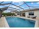 A luxurious, screened-in pool with stone accents, outdoor seating, and access to the house at 17610 Polo Trl, Bradenton, FL 34211