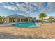Gorgeous pool area with a clubhouse, palm trees, and a splash area offering a resort-like experience at 17610 Polo Trl, Bradenton, FL 34211