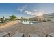 Luxurious pool area featuring lounge chairs, umbrellas, and a clubhouse in a resort-style setting at 17610 Polo Trl, Bradenton, FL 34211