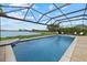 Enjoy the screened-in pool overlooking the lake and the gorgeous pool deck at 17610 Polo Trl, Bradenton, FL 34211