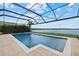 Inviting in-ground screened pool and a relaxing lake view under a bright blue sky at 17610 Polo Trl, Bradenton, FL 34211