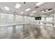 Spacious studio showcasing hardwood floors, a mirrored wall, and ample natural light for creative endeavors at 17610 Polo Trl, Bradenton, FL 34211