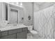 Clean bathroom with a shower-tub combo, a gray vanity, a white quartz countertop, and neutral decor at 17814 Cresswind Ter, Bradenton, FL 34211