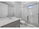 A sleek bathroom with a glass-enclosed shower, modern vanity, and elegant white and gray finishes at 17814 Cresswind Ter, Bradenton, FL 34211