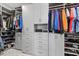 Walk-in closet with shelving and storage, with hanging clothes, shoes, and accessories at 17814 Cresswind Ter, Bradenton, FL 34211