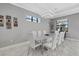 Bright dining room with modern lighting fixture, table and chairs, with a large window view at 17814 Cresswind Ter, Bradenton, FL 34211