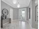 Elegant foyer with marble floors, modern lighting, and a glass front door for ample natural light at 17814 Cresswind Ter, Bradenton, FL 34211