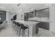 Spacious kitchen featuring a large island, modern lighting, gray cabinets, and high-end appliances at 17814 Cresswind Ter, Bradenton, FL 34211