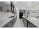 Modern kitchen featuring gray cabinetry, premium stainless steel appliances, and elegant granite countertops at 17814 Cresswind Ter, Bradenton, FL 34211