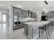 Modern kitchen with gray cabinets, stainless steel appliances, a large island, and granite countertops at 17814 Cresswind Ter, Bradenton, FL 34211