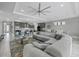Open-concept living space with a large sofa, modern lighting, and a view of the kitchen and dining area at 17814 Cresswind Ter, Bradenton, FL 34211