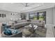 Bright living room featuring a large sectional sofa, stylish chairs, and a view of the screened in lanai at 17814 Cresswind Ter, Bradenton, FL 34211