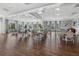 Bright meeting room with hardwood floors, tables, chairs, and large windows offering natural light at 17814 Cresswind Ter, Bradenton, FL 34211