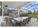 Covered outdoor kitchen featuring stainless steel appliances, a granite countertop, and an outdoor dining area at 17814 Cresswind Ter, Bradenton, FL 34211