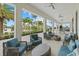 Inviting outdoor patio with comfortable seating, ceiling fans, and lush tropical landscaping at 17814 Cresswind Ter, Bradenton, FL 34211