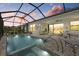 Inviting screened-in pool with connected spa and view of outdoor seating area, perfect for entertaining at 17814 Cresswind Ter, Bradenton, FL 34211