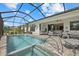 A stunning screened-in pool with a spa and outdoor seating area, perfect for relaxation and entertaining at 17814 Cresswind Ter, Bradenton, FL 34211