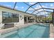 An inviting screened-in pool features a spa, outdoor kitchen, and plenty of seating for entertaining at 17814 Cresswind Ter, Bradenton, FL 34211