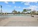Beautiful community pool surrounded by palm trees, lounge chairs, and shaded seating areas at 17814 Cresswind Ter, Bradenton, FL 34211