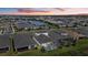 Aerial view of a modern home with a screened-in pool and backyard overlooking a lake at sunset at 17814 Cresswind Ter, Bradenton, FL 34211