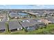 Aerial view of a modern home with a screened-in pool and backyard overlooking a lake in a Primary-planned community at 17814 Cresswind Ter, Bradenton, FL 34211