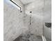 Bright shower with dual shower heads, a built-in seat, a hand rail, and glass doors at 17814 Cresswind Ter, Bradenton, FL 34211