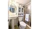 Bathroom featuring pedestal sink, glass shower, and beach-themed decor at 2057 Sunset Dr # G1, Bradenton, FL 34207