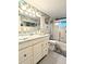 Bathroom with a tile countertop, vanity, and shower with glass doors at 2057 Sunset Dr # G1, Bradenton, FL 34207