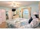 Bedroom with nautical-themed bedding and decor, light blue walls, and neutral carpeting at 2057 Sunset Dr # G1, Bradenton, FL 34207