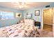 Bedroom with light blue walls, nautical-themed bedding, dresser, and neutral carpeting at 2057 Sunset Dr # G1, Bradenton, FL 34207