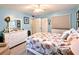 Cozy bedroom featuring light blue walls, a white dresser, and nautical-themed bedding at 2057 Sunset Dr # G1, Bradenton, FL 34207
