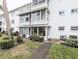 Exterior view of condo building featuring private, screened lanais on each level at 2057 Sunset Dr # G1, Bradenton, FL 34207