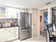 View of kitchen featuring stainless steel appliances, white cabinetry, tile backsplash, and granite countertops at 2057 Sunset Dr # G1, Bradenton, FL 34207