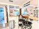 Bright kitchen bar area features two stools, granite counters, wine rack and elegant stemware rack at 2057 Sunset Dr # G1, Bradenton, FL 34207
