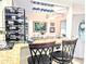 Kitchen bar area features two stools, granite counters, wine rack and elegant stemware rack at 2057 Sunset Dr # G1, Bradenton, FL 34207
