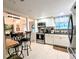View of kitchen featuring stainless steel appliances, white cabinetry, tile backsplash, and granite countertops at 2057 Sunset Dr # G1, Bradenton, FL 34207