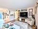 Living room area showcases an entertainment center with mounted tv and electric fireplace at 2057 Sunset Dr # G1, Bradenton, FL 34207