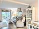 Bright living room features coastal decor and a sliding door that leads to a porch at 2057 Sunset Dr # G1, Bradenton, FL 34207
