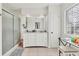 Bathroom featuring a walk-in shower, vanity, and a window for natural light at 2219 12Th W Ave, Bradenton, FL 34205