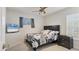 Cozy bedroom with a decorative ceiling fan, large window, and a TV mounted on the wall at 2219 12Th W Ave, Bradenton, FL 34205