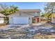 Inviting two-story home with a spacious driveway, a two-car garage, and a vibrant red front door at 2219 12Th W Ave, Bradenton, FL 34205