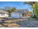 Beautiful two-story home with a two-car garage, a vibrant red front door, and a well-maintained yard at 2219 12Th W Ave, Bradenton, FL 34205