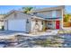 Charming two-story home featuring a two-car garage, a welcoming red front door, and well-kept landscaping at 2219 12Th W Ave, Bradenton, FL 34205