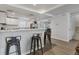 Open kitchen featuring stone countertops, bar stool seating, a stainless steel refrigerator, and hardwood floors at 2219 12Th W Ave, Bradenton, FL 34205