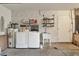 Functional laundry room with modern appliances, sink, and shelving for efficient organization at 2219 12Th W Ave, Bradenton, FL 34205