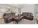 Comfortable living room featuring hardwood floors, recessed lighting, and two reclining sofas around a wood coffee table at 2219 12Th W Ave, Bradenton, FL 34205